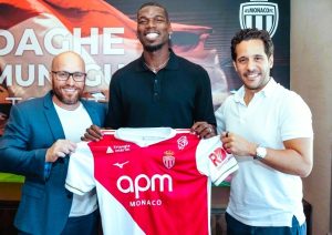 Paul Pogba poses in Monaco's red-and-white kit after signing a two-year contract, returning to Ligue 1 for the first time.