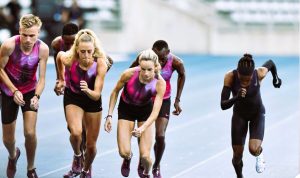 Faith Kipyegon sprinting in an aerodynamic skinsuit on a professional track, surrounded by pacemakers during her record-breaking mile attempt in Paris.