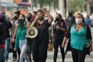 Community members gathered around a memorial during a Juneteenth ceremony at the African Burying Ground in Portsmouth, New Hampshire.
