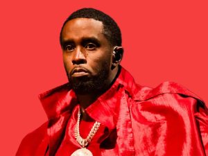 Sean “Diddy” Combs seated in court with head bowed, surrounded by attorneys during jury deliberations.