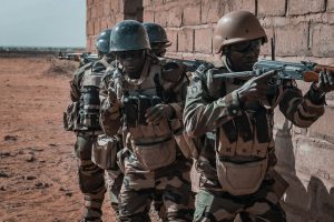 Nigerian soldiers and police officers patrolling in a rural area after a counter-attack on armed groups in the northwest.