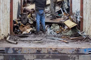 Zimbabwean scrap metal collectors push carts through Harare dumps to reduce waste and earn a living.