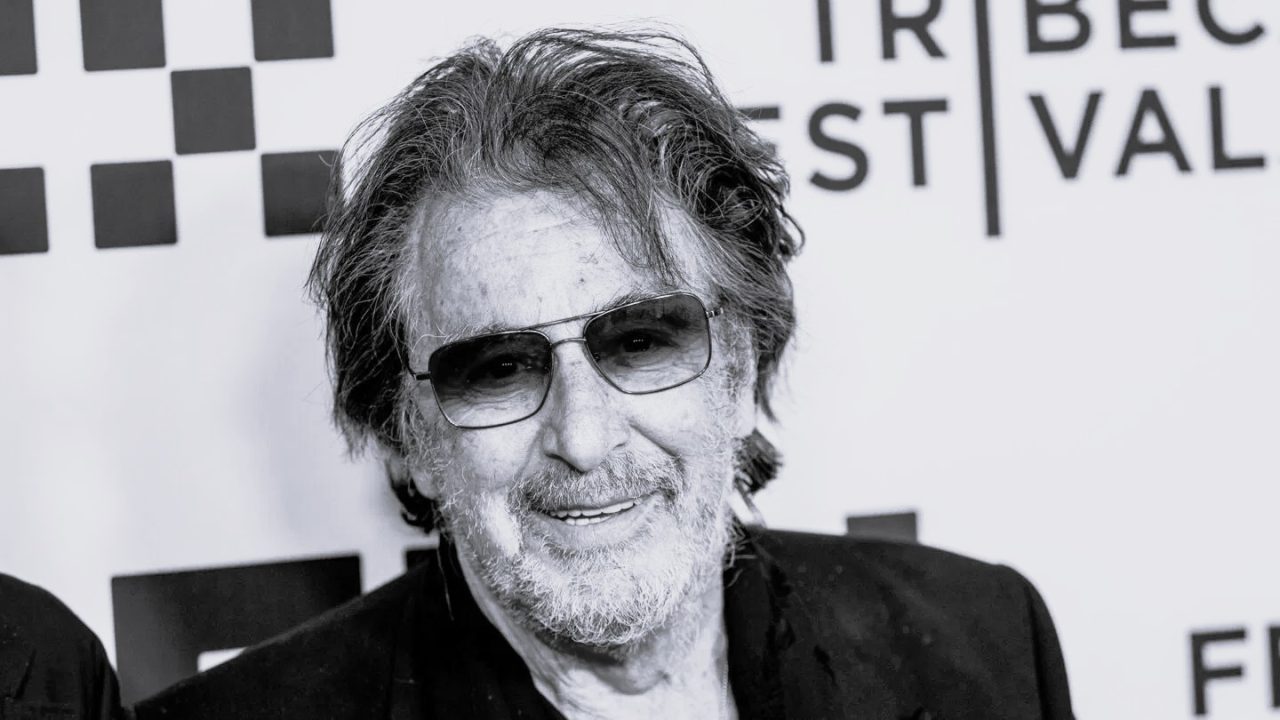 Al Pacino smiling at an event, reflecting on fatherhood and his acting career.