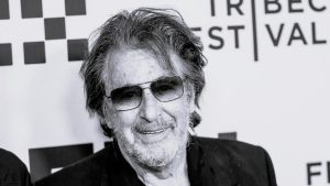 Al Pacino smiling at an event, reflecting on fatherhood and his acting career.