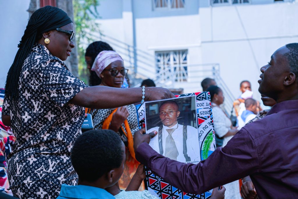 Congolese Catholics hold a banner with the image of Floribèrt Kositi during beatification celebrations in Goma.