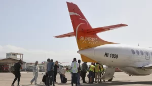 A Sunrise Airways plane prepares for departure at Port-au-Prince airport as passengers and staff mark the resumption of commercial flights after months of gang-related shutdowns.
