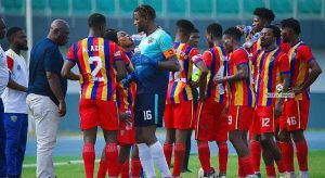 Accra Hearts of Oak players during a team huddle at the Accra Sports Stadium before a match.