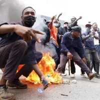 Demonstrators face off with men carrying clubs in central Nairobi during protests over police brutality and blogger’s death.