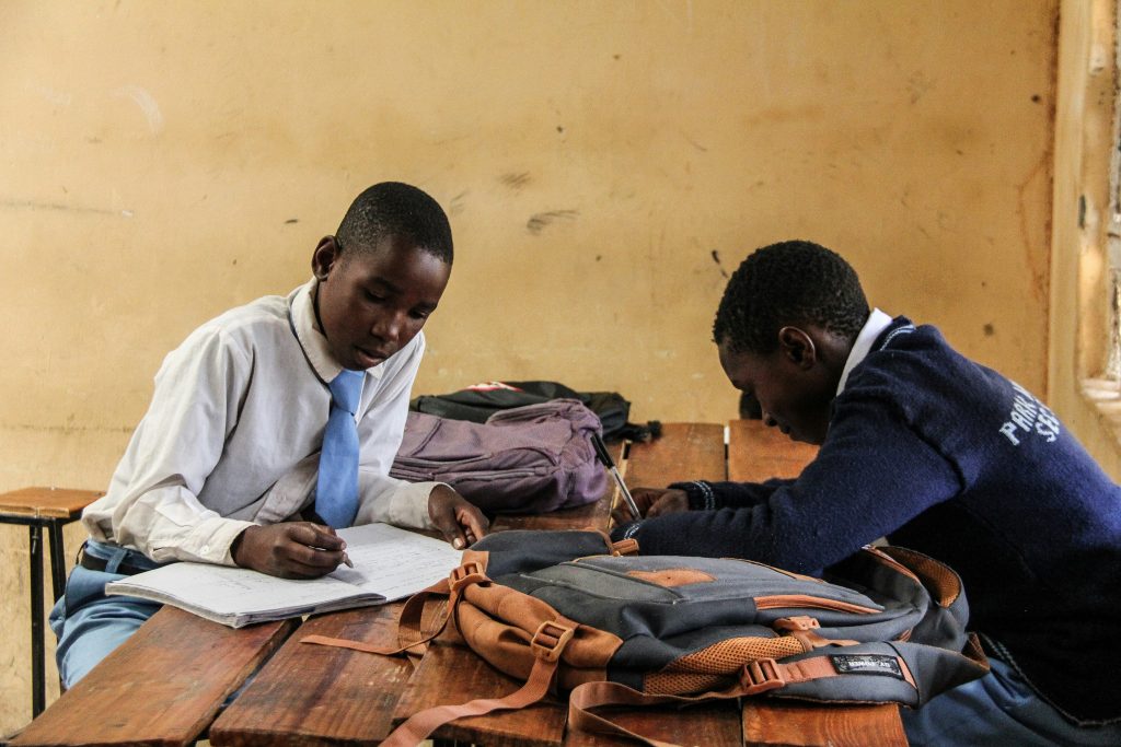 Students fleeing an exam hall in panic, with emergency responders helping the wounded after a tragic stampede in Bangui, Central African Republic.