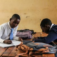 Students fleeing an exam hall in panic, with emergency responders helping the wounded after a tragic stampede in Bangui, Central African Republic.