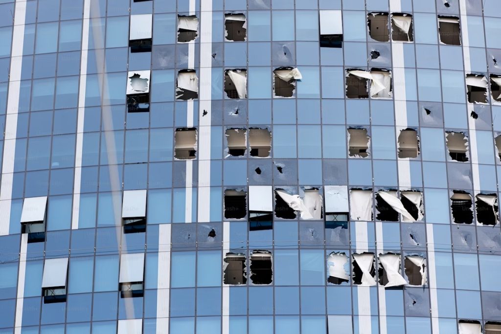 A shopkeeper stands amid broken glass in Nairobi following the Saba Saba protests that turned violent on July 7, 2025.