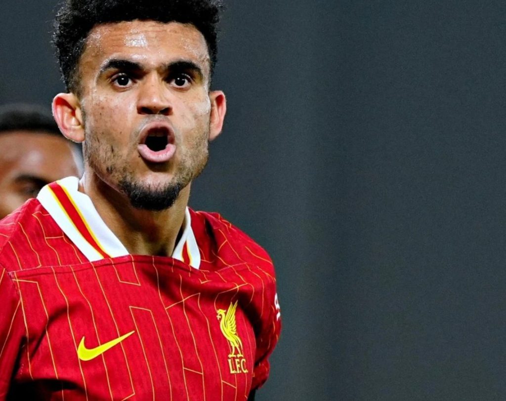 Luis Diaz in action for Liverpool, dribbling past defenders during a Premier League match.