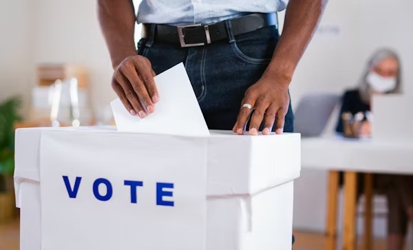 Togolese police officers and soldiers voting at a polling station during early municipal elections in Lomé.