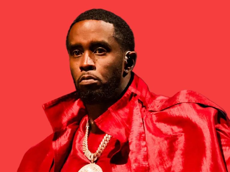 Sean “Diddy” Combs seated in court with head bowed, surrounded by attorneys during jury deliberations.