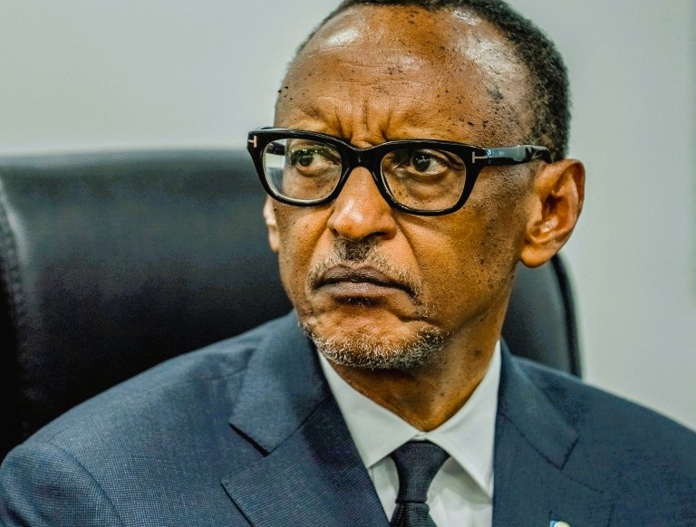 Rwandan President Paul Kagame seated in a government meeting, announcing leadership changes in Kigali. Ask ChatGPT