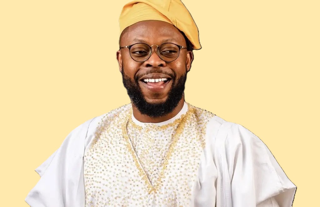 Ghanaian comedian Kalybos smiling in front of a crowd, known for his role in Boys Kasa and his humble connection with fans.