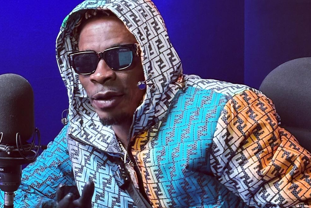 Shatta Wale performing on stage at the Accra Sports Stadium during the 2025 President’s Cup, surrounded by dancers and lights.