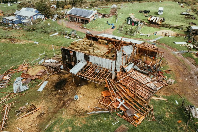 Flooded homes and rescue workers navigating submerged streets in Eastern Cape, South Africa, following severe rains.