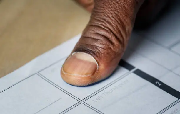 Citizens in the Central African Republic reading provisional voter lists posted on a wall at a polling station in Bangui.