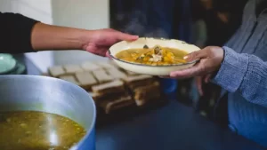 South African volunteer chefs preparing large pots of soup in a community kitchen on Mandela Day, as part of a national campaign to feed the hungry.