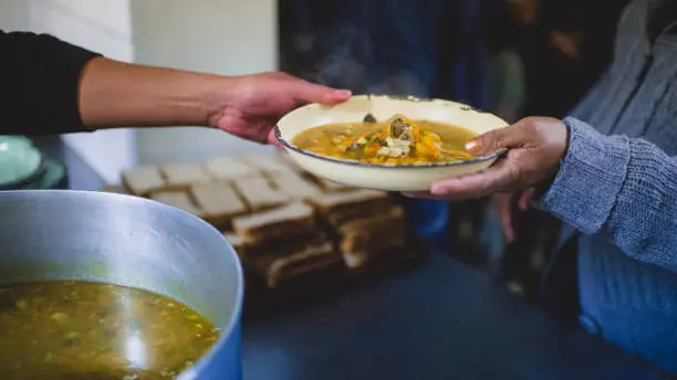 South African volunteer chefs preparing large pots of soup in a community kitchen on Mandela Day, as part of a national campaign to feed the hungry.
