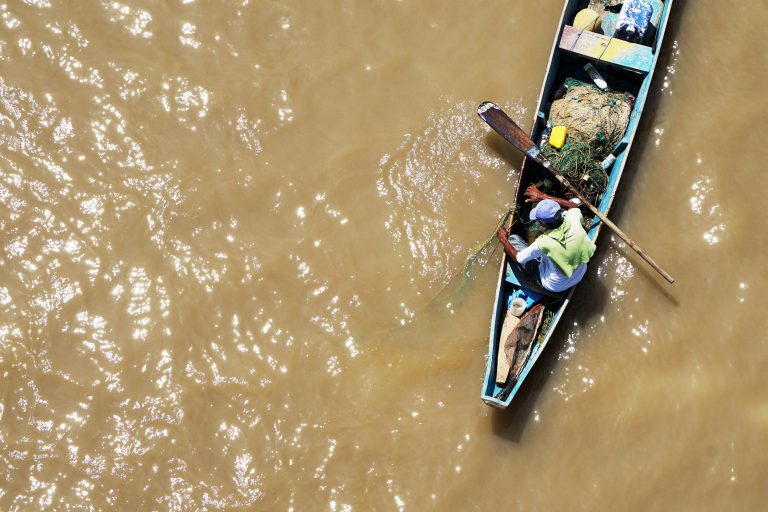 Nigerian rescue workers and residents near the site of a capsized ferry in Niger State.