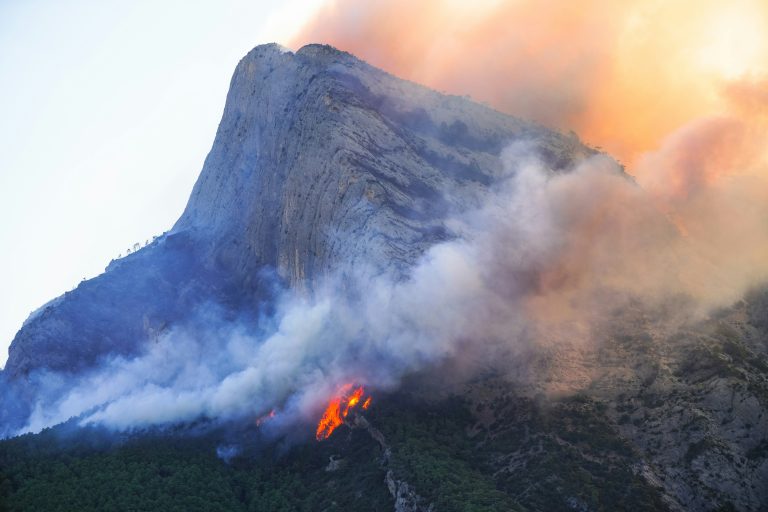 More than 100 injured as French firefighters battle raging wildfire near Marseille. Blaze slows, but containment efforts continue.
