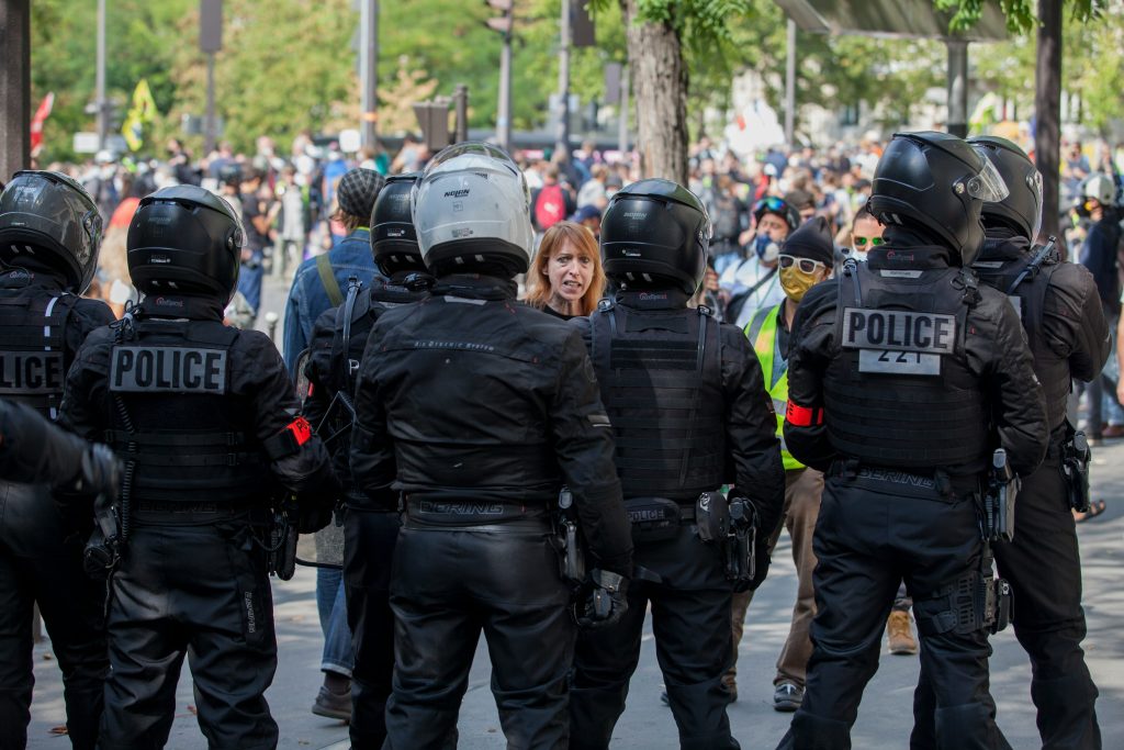 Spanish riot police with helmets and shields standing guard during unrest in Torre Pacheco, Murcia.