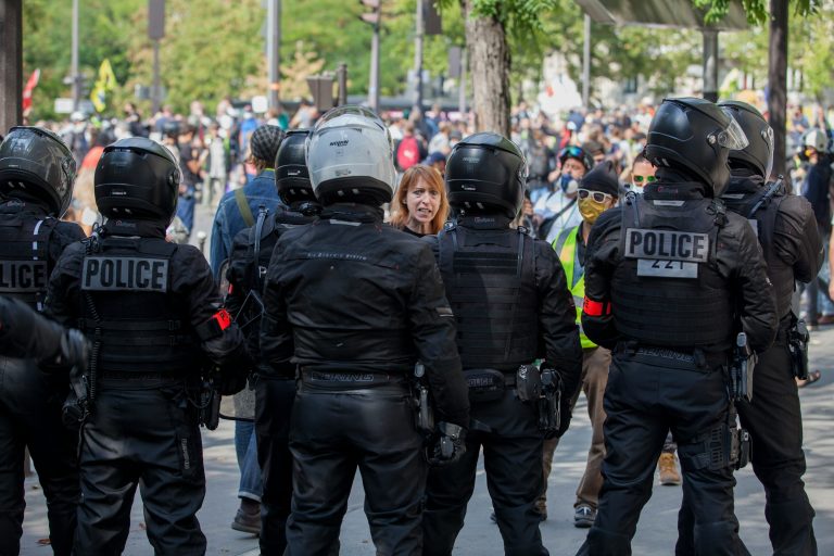 Spanish riot police with helmets and shields standing guard during unrest in Torre Pacheco, Murcia.